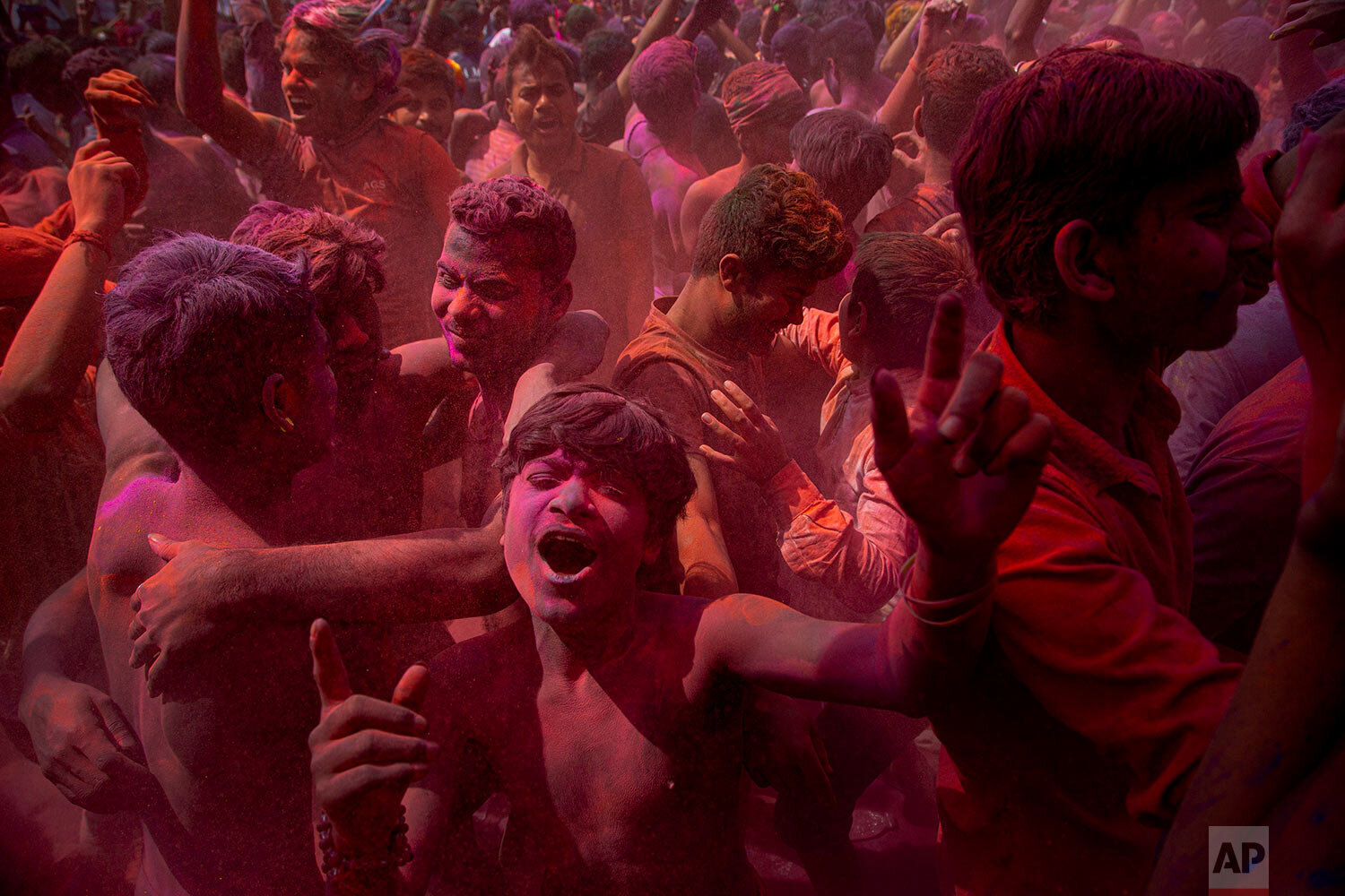  Indians dance and throw colored powder during Holi festival celebrations in Gauhati, India, Tuesday, March 10, 2020. (AP Photo/Anupam Nath) 
