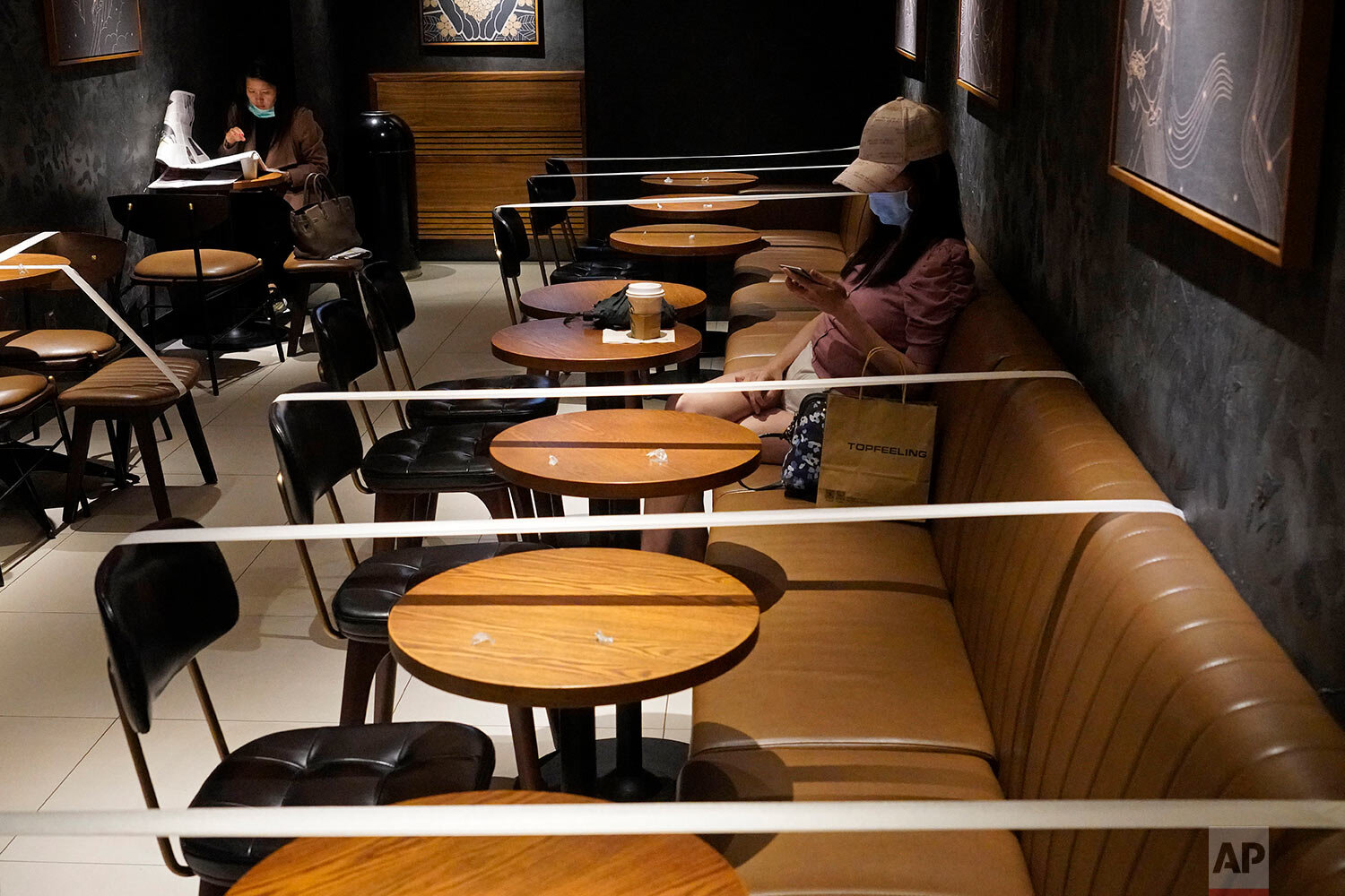  Tables and chairs are taped for the social distancing law enforcement to help curb the spread of the coronavirus at a Starbucks coffee shop in Hong Kong, Monday, March 30, 2020. (AP Photo/Vincent Yu) 