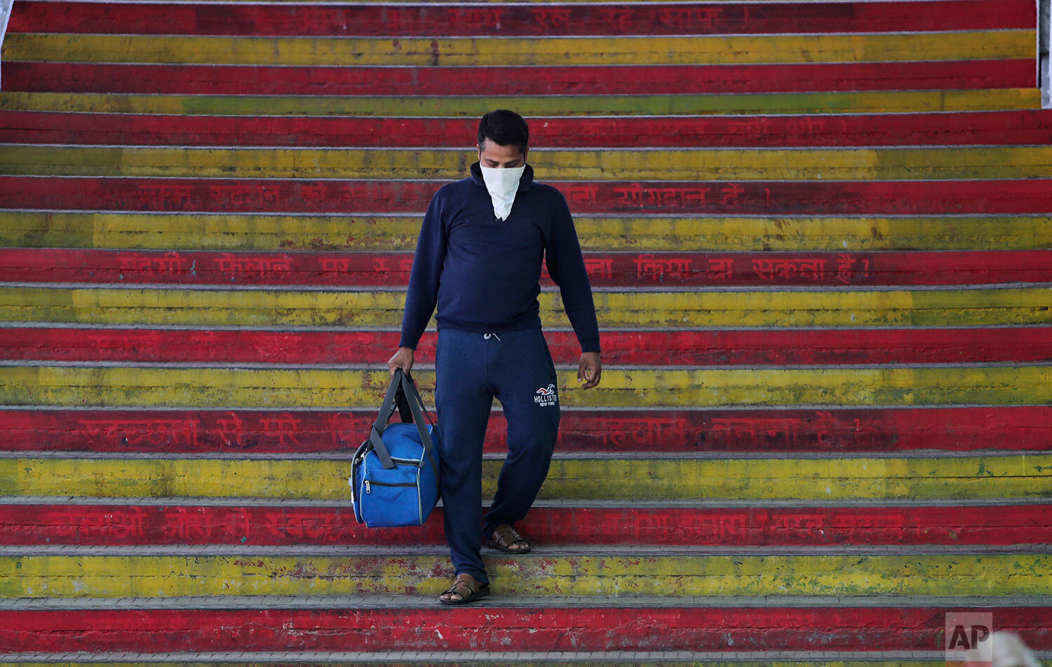  Indian passenger wearing a mask arrives a railway station in Jammu, India, Sunday, March 22, 2020.  (AP Photo/Channi Anand) 