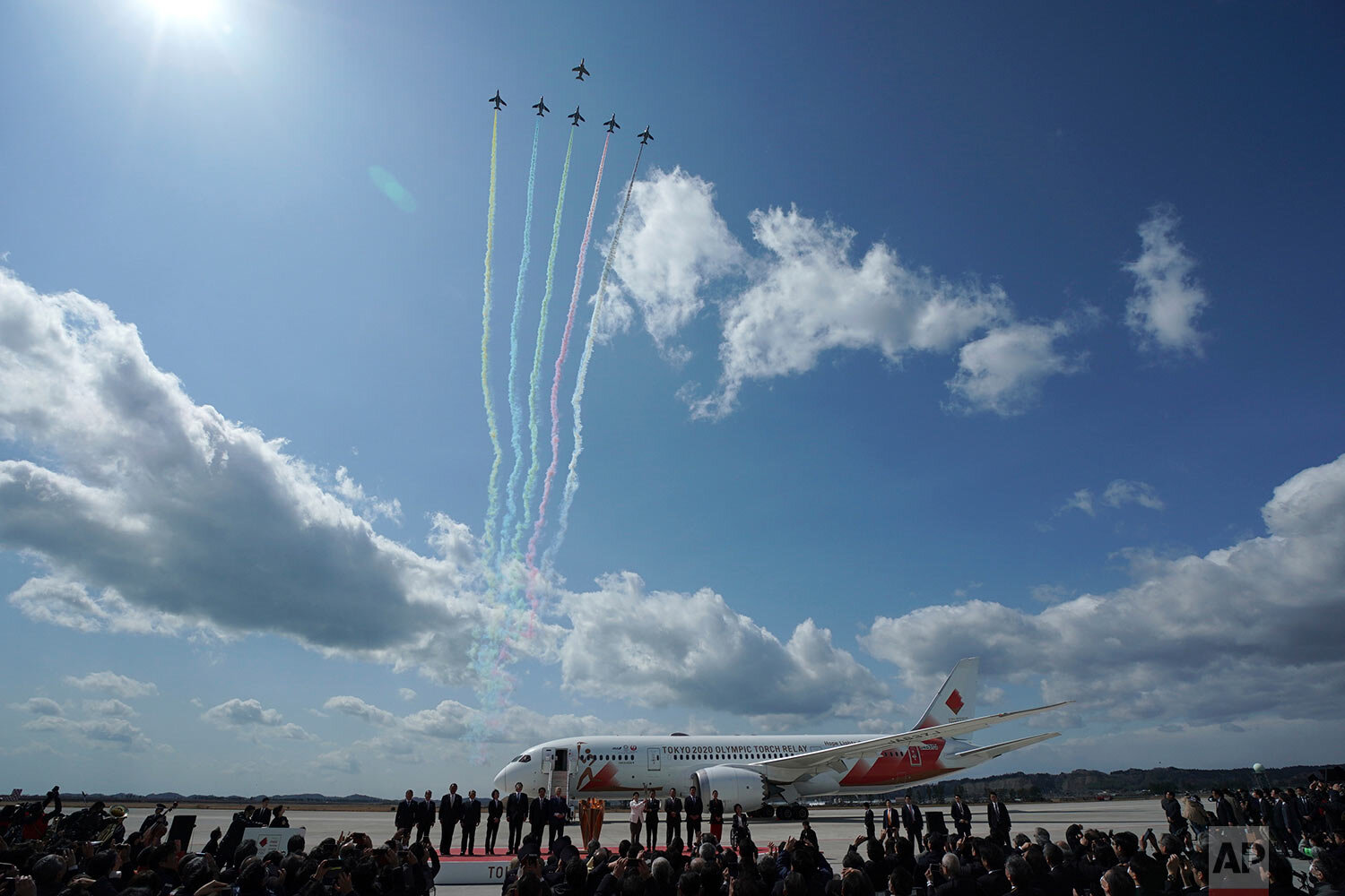  Blue Impulse of the Japan Air Self-Defense Force fly over during Olympic Flame Arrival Ceremony at Japan Air Self-Defense Force Matsushima Base in Higashimatsushima in Miyagi Prefecture, north of Tokyo, Friday, March 20, 2020. (AP Photo/Eugene Hoshi