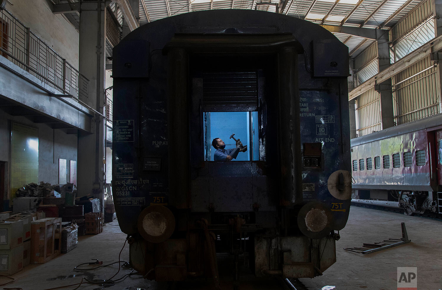  An Indian railway employee works to convert a train coach into an isolation ward for the fight against the new coronavirus in Gauhati, India, Sunday, March 29, 2020. (AP Photo/Anupam Nath) 