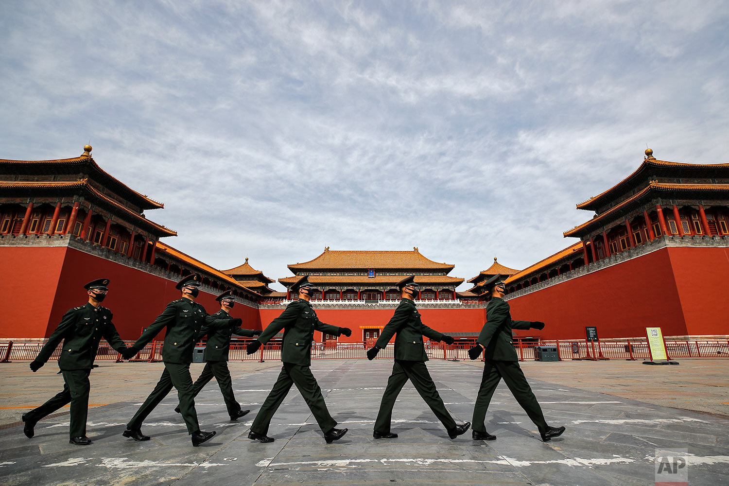 Soldiers wearing protective face masks march past the closed entrance gates to the Forbidden City, usually crowded with tourists before the new coronavirus outbreak in Beijing, Thursday, March 12, 2020.  (AP Photo/Andy Wong) 