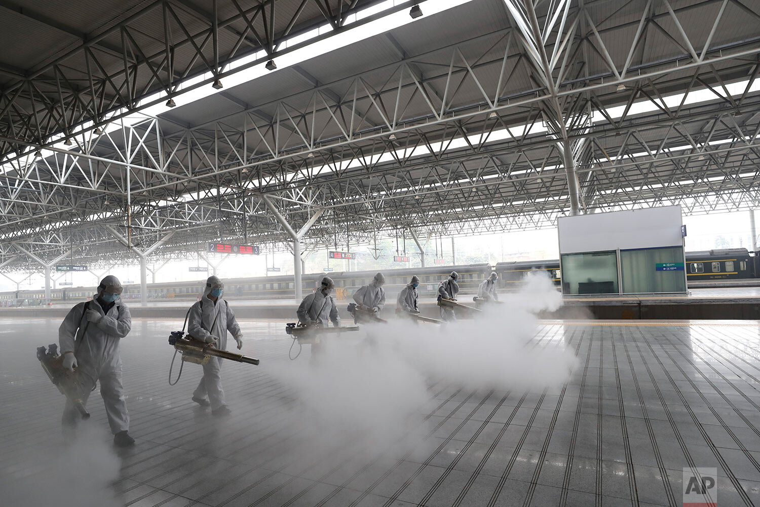  In this photo released by Xinhua News Agency, firefighters conduct disinfection on the platform at Yichang East Railway Station in Yichang, in central China's Hubei Province, Tuesday, March 24, 2020. (Photo by Wang Shen/Xinhua) 