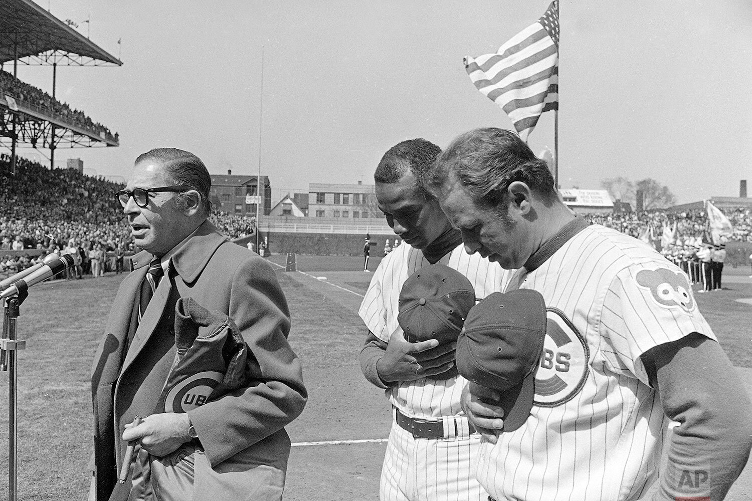  Chicago Cubs co-captains Ernie Banks and Ron Santo, right, bow heads as master of ceremonies Milton Berle leads opening-day crowd in prayer for safe return of Apollo 13 astronauts Tuesday, April 14, 1970 in Chicago. Cubs played Philadelphia before a