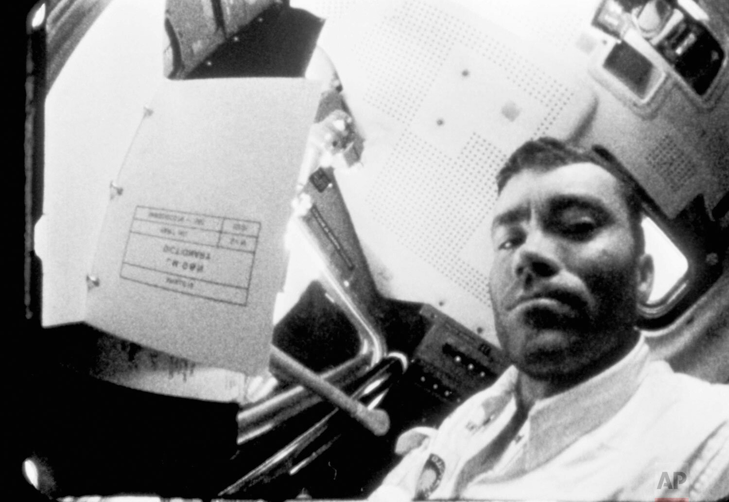  Apollo 13 lunar module pilot Fred W. Haise Jr., watches flight plans float away in the cabin of the lunar module as the damaged spacecraft headed back to earth after the oxygen tank explosion which nearly wrecked the ship. This photo was taken from 