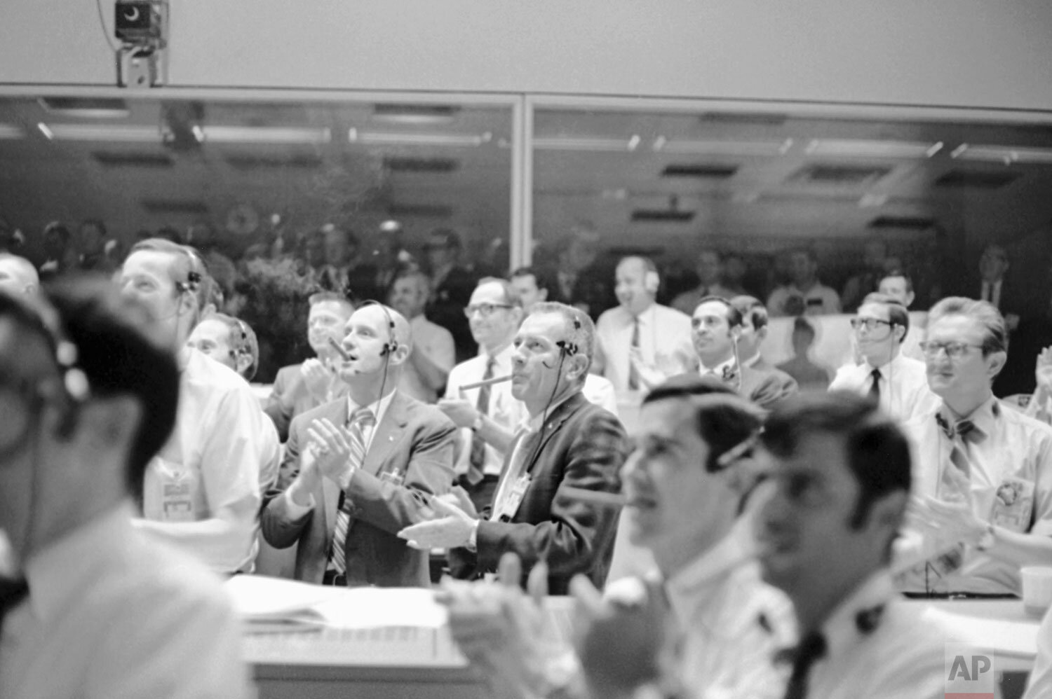  Astronaut Thomas Stafford, left, and Donald Slayton, Director of Flight Crew Operations, puff on big cigars and applaud as the Apollo 13 made a successful splashdown, April 17, 1970, Houston, Tex. (AP Photo) 