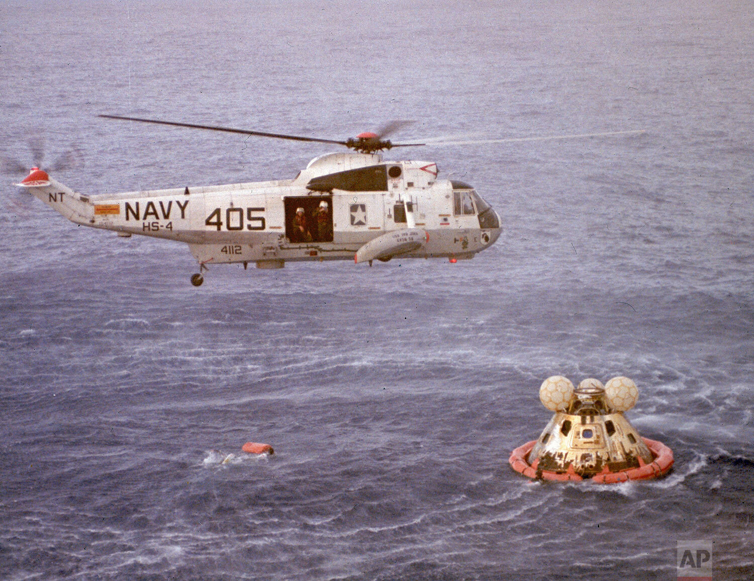  The Command Module Odyssey of the Apollo 13 space mission floats in the Pacific Ocean after splashdown near Samoa, April 17, 1970 while a U.S. Navy helicopter from the recovery ship U.S.S. Iwo Jima attempts to rescue the crew of three astronauts. (A
