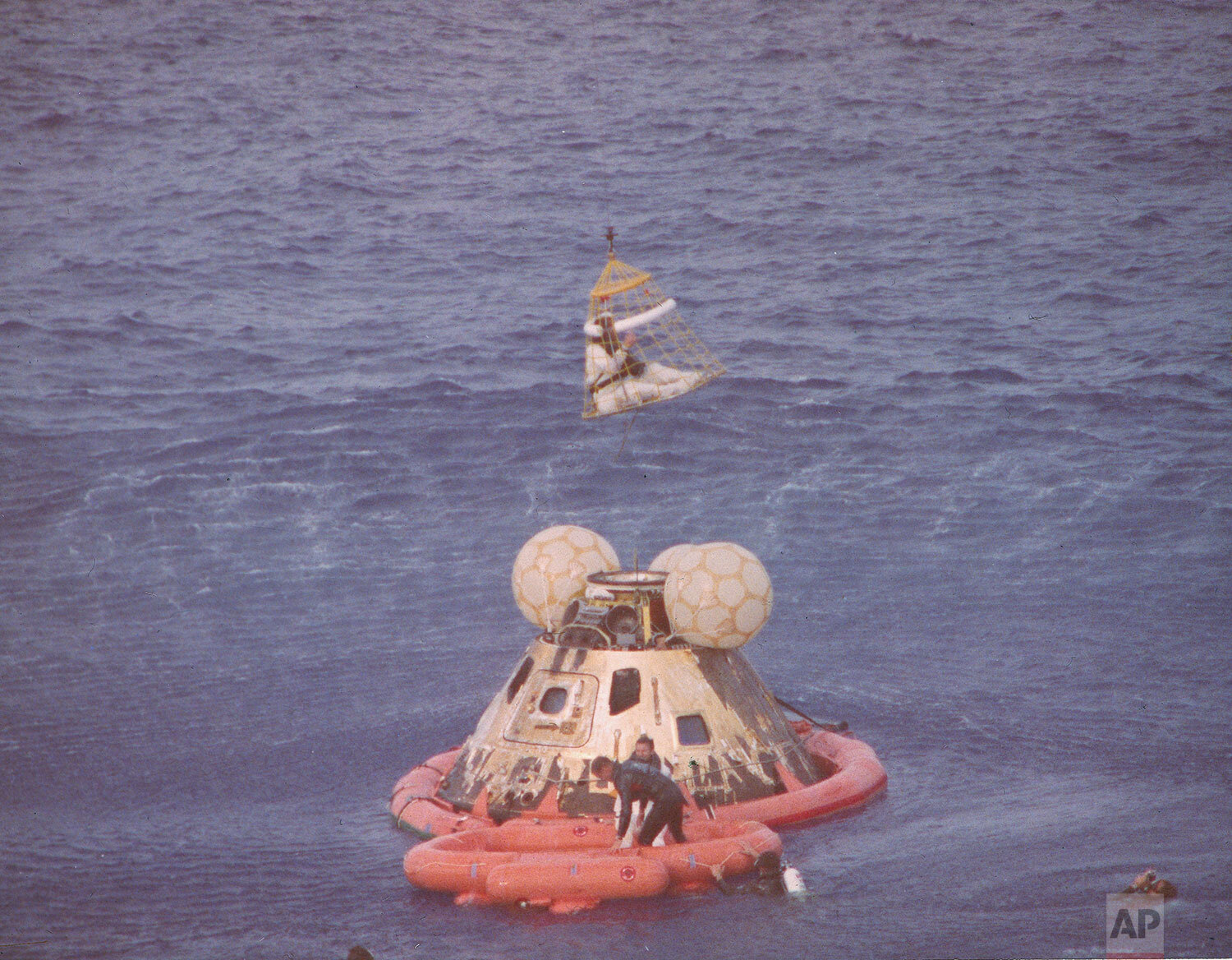 The Command Module Odyssey of the Apollo 13 space mission floats in the Pacific Ocean after splashdown near Samoa, April 17, 1970 while Navy personnel attempt to rescue the crew of three astronauts. (AP Photo) 