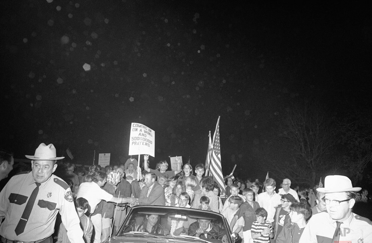  Residents of Timber Cove near the Manned Spacecraft Center greet their favorite neighbor, Apollo 13 commander James Lovell Jr., as he arrived at his home, April 19, 1970, Houston, Tex. (AP Photo) 