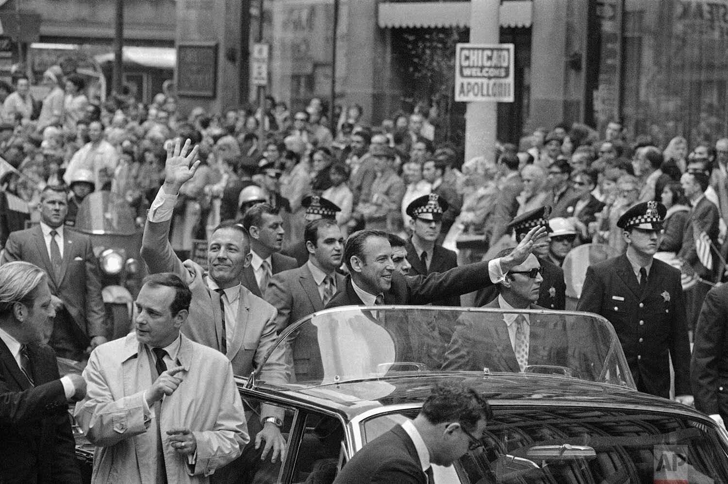  Apollo 13 astronauts John Swigert Jr., with his arms upraise and James Lovell ride in parade in their honor, Friday, May 2, 1970 through Chicagos financial district as confetti streams from the skyscrapers. (AP Photo) 