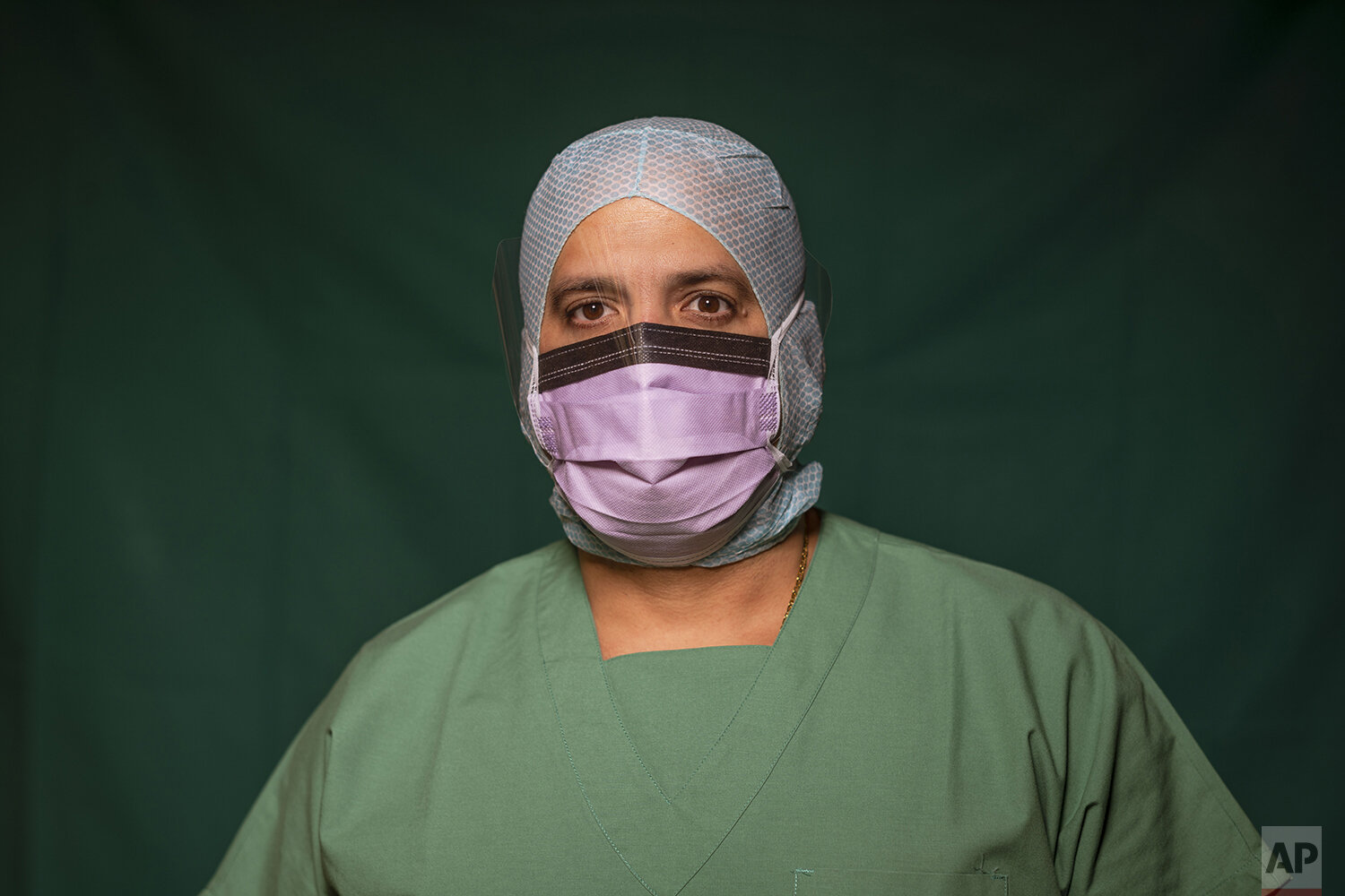  Adriano Rodriguez, 48, an ICU nurse at Rome's COVID 3 Spoke Casalpalocco Clinic poses for a portrait, Friday, March 27, 2020, during a break in his daily shift. (AP Photo/Domenico Stinellis) 