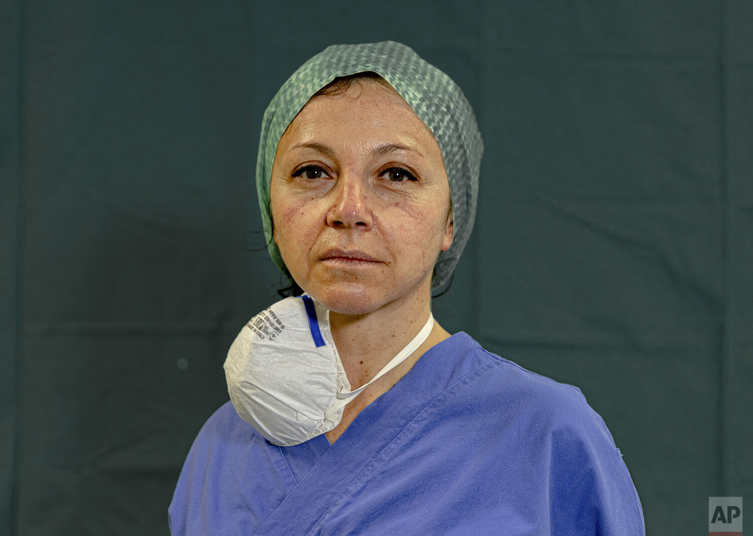  In this image taken on Friday, March 27, 2020, intensive care unit nurse Michela Pagati, 48, poses for a photo at the Brescia Spedali Civili Hospital, in Brescia, Italy. (AP Photo/Luca Bruno) 