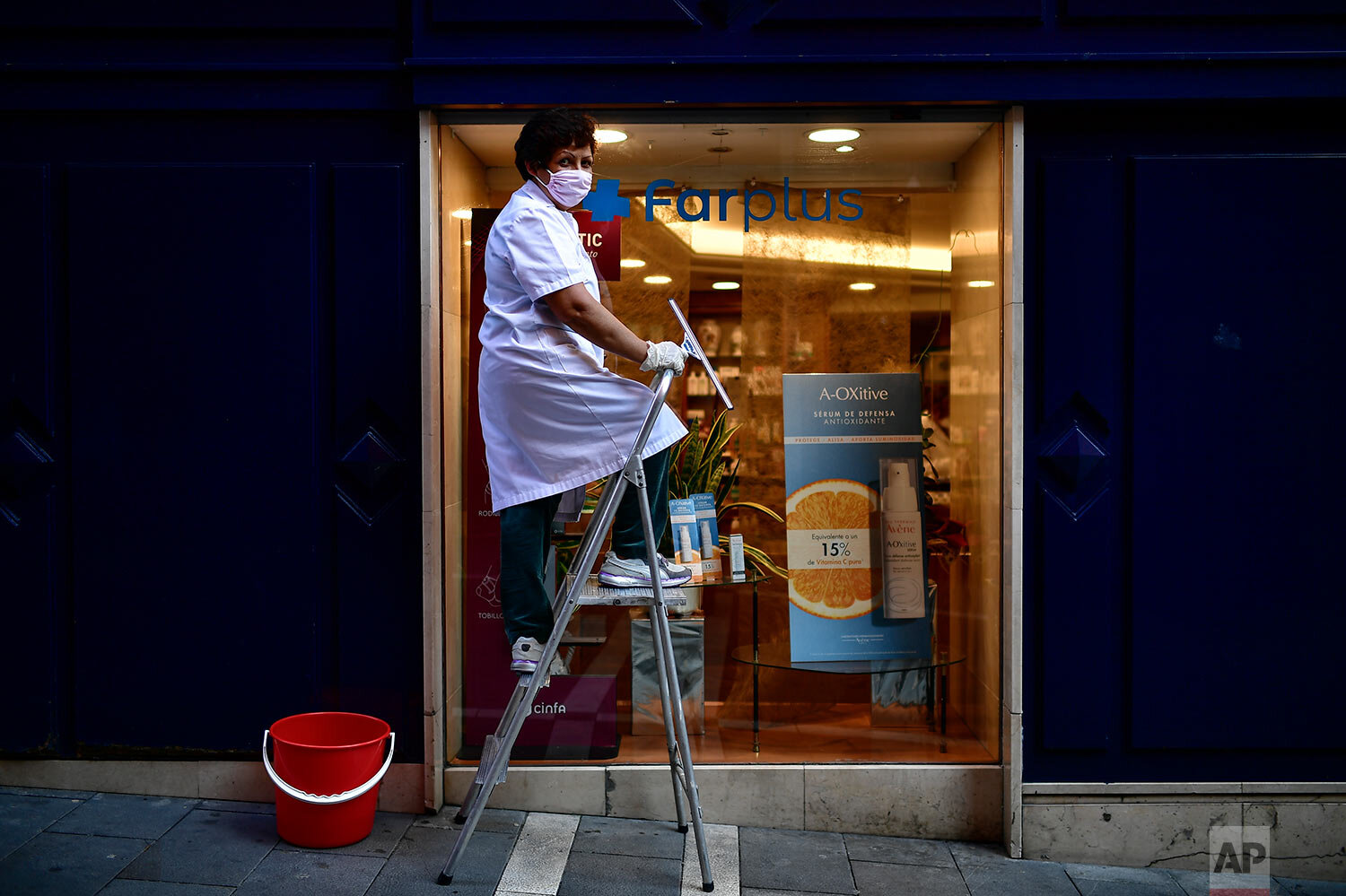  Matilde Mattos, of Peru, poses for a photograph as she clean windows in Pamplona, northern Spain. (AP Photo/Alvaro Barrientos) 