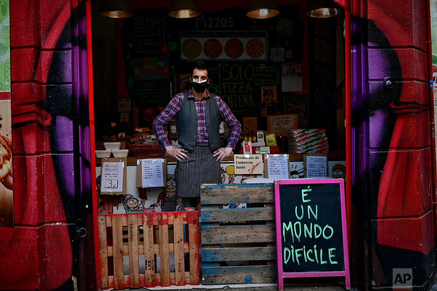  Miguel Angel Pena poses for a photograph in his food store in Pamplona, northern Spain. (AP Photo/Alvaro Barrientos) 