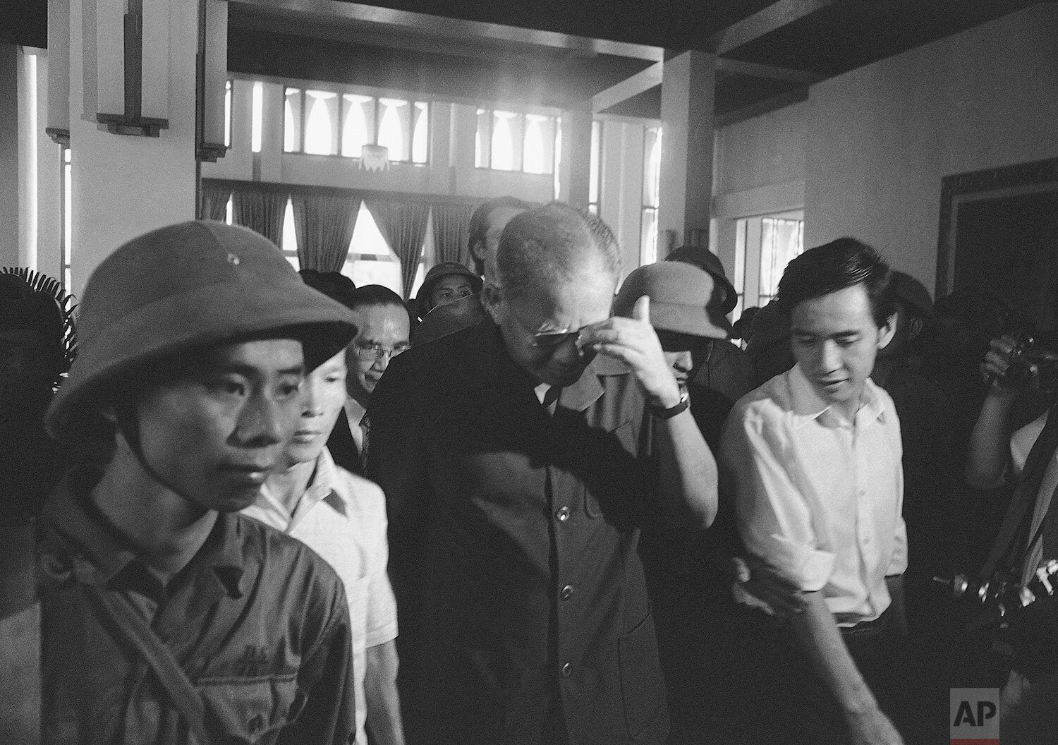  Defeated South Vietnam President Duong Van Minh (middle) walks out of Independence Palace after surrendering to PRG forces in Saigon on May 1, 1975. (AP Photo/Billy) 