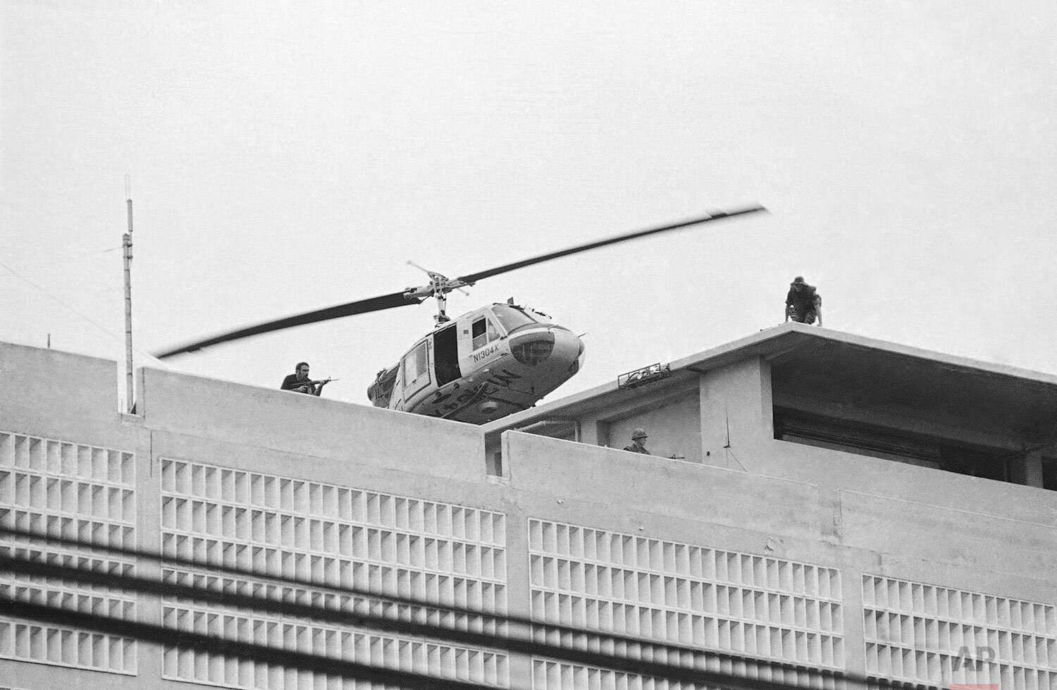  A U.S. Marine helicopter takes off from helipad on top of the American Embassy in Saigon, Vietnam, April 30, 1975. (AP Photo/Phu) 