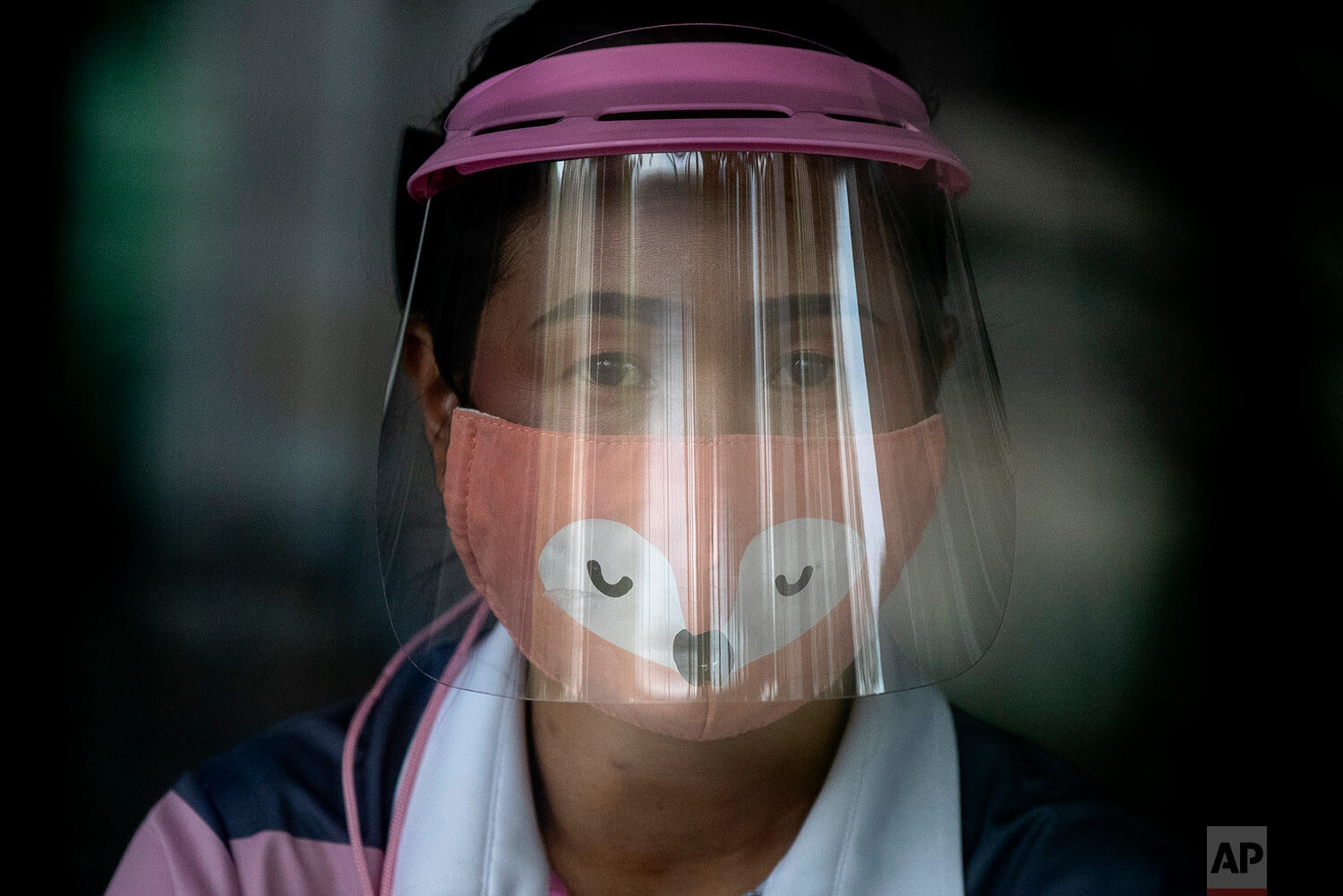  A volunteer wearing a face shield and mask manages a counter of COVID-19 infection screening center at the Chulalongkorn University health service center in Bangkok, Thailand, Wednesday, April 1, 2020. (AP Photo/Gemunu Amarasinghe) 