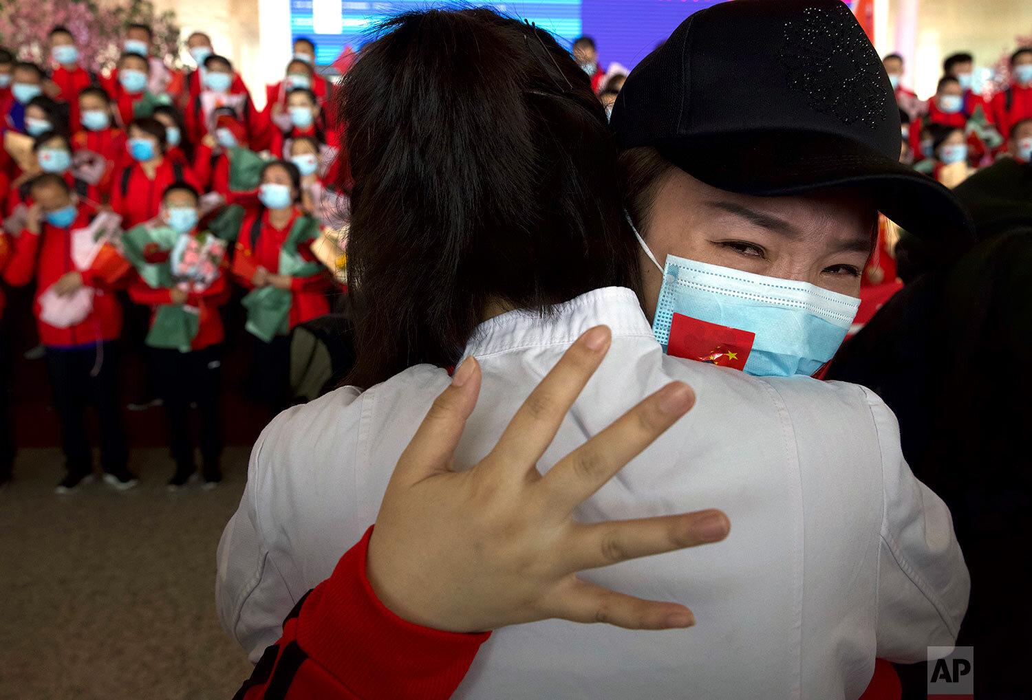  A medical worker from China's Jilin Province reacts as she prepares to return home at Wuhan Tianhe International Airport in Wuhan in central China's Hubei Province, April 8, 2020. (AP Photo/Ng Han Guan) 