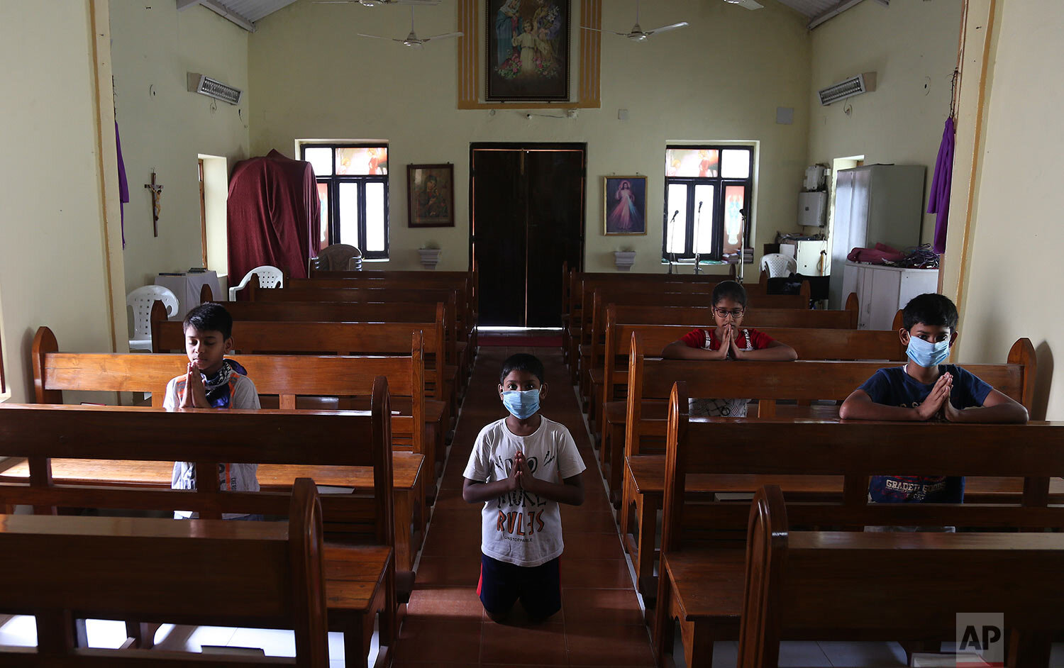  Catholic devotees offer prayers at Our Lady of Lourdes Church on Good Friday, during a lockdown to control the spread of the new coronavirus in Hyderabad, India, Friday, April 10, 2020.  (AP Photo/Mahesh Kumar A.) 