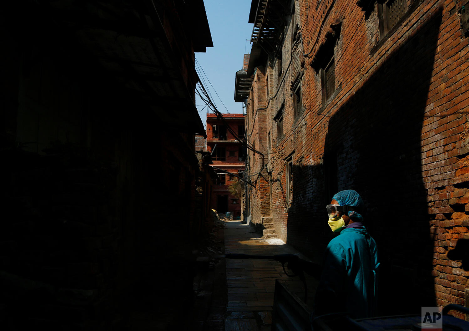  A Nepalese volunteer sprays disinfectants at a residential area as a precautionary measure against COVID-19 in Bhaktapur, Nepal, Monday, April 6, 2020. (AP Photo/Niranjan Shrestha) 