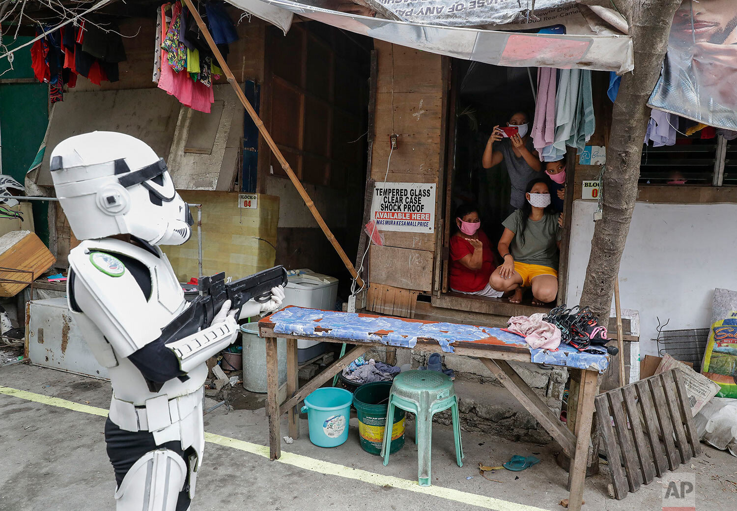  Members of a youth group in Star Wars costumes entertain locals along a road in Malabon, Metro Manila, Philippines, Thursday, April 30, 2020. (AP Photo/Aaron Favila) 