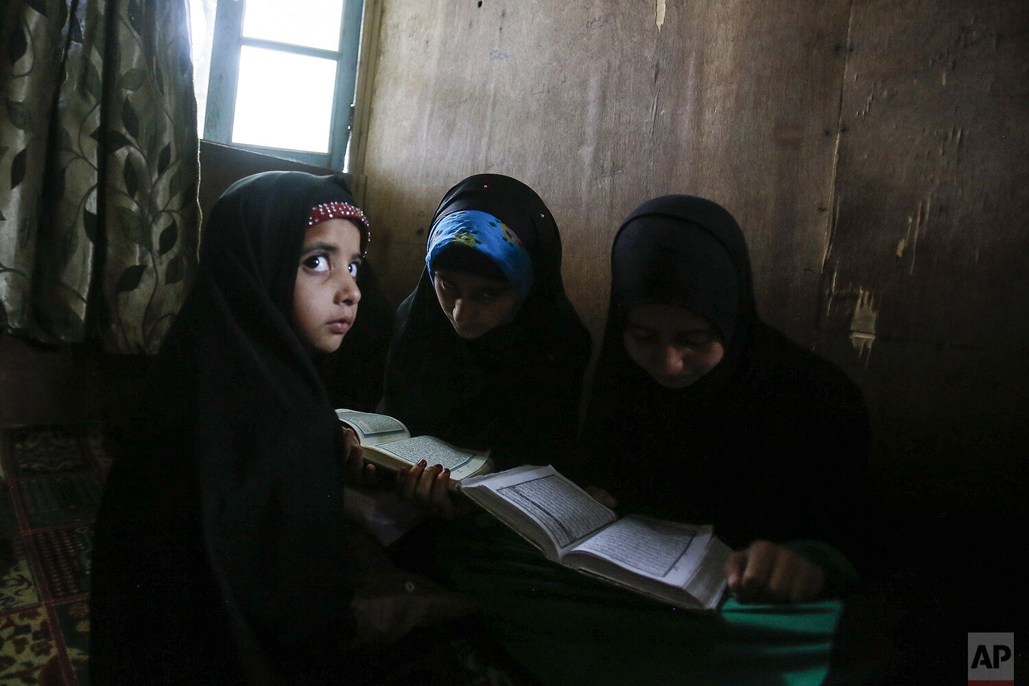  Kashmiri Muslim children attend recitation classes of the holy Quran on the first day of the fasting month of Ramadan in Srinagar, Indian controlled Kashmir, May 7, 2019. (AP Photo/Mukhtar Khan) 