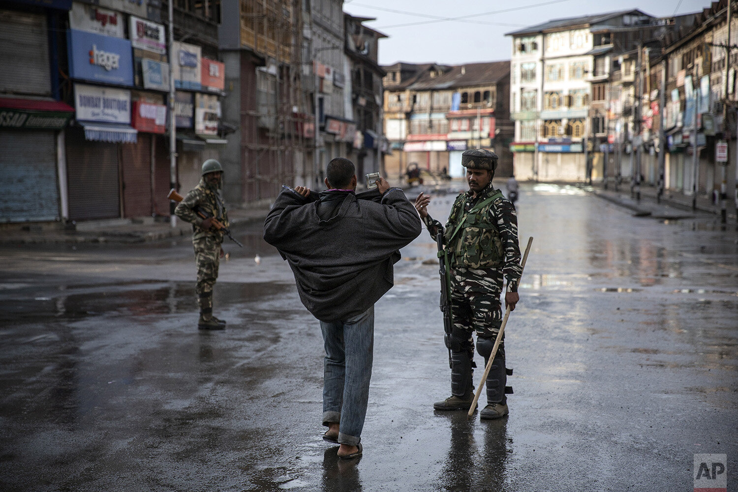  An Indian paramilitary soldier orders a Kashmiri to open his jacket before frisking him during curfew in Srinagar, Indian controlled Kashmir, Aug. 8, 2019. The beautiful Himalayan valley is flooded with soldiers and roadblocks of razor wire. (AP Pho