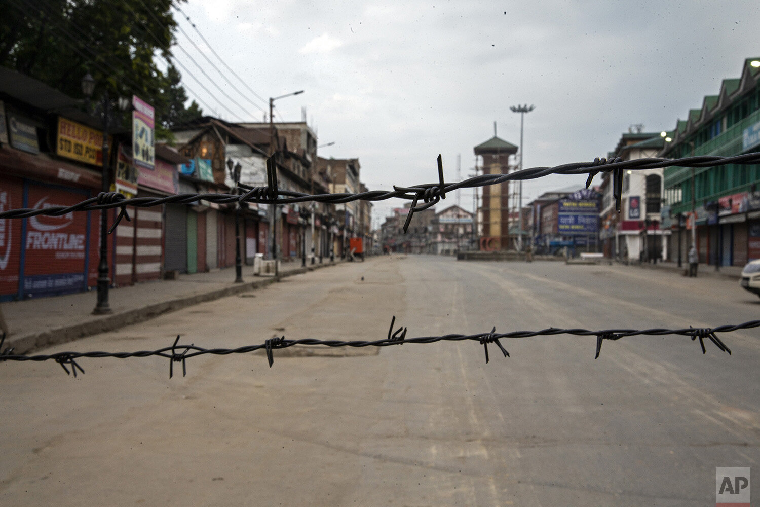  A deserted street is seen through barbwire set up as a blockade during curfew in Srinagar, Indian controlled Kashmir, Aug. 6, 2019. (AP Photo/Dar Yasin) 