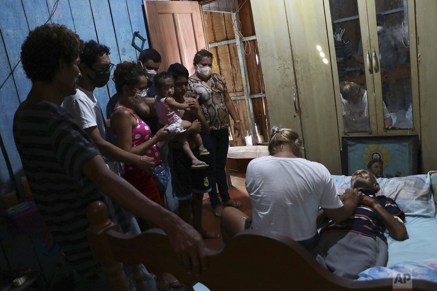  Relatives gather around the body of Raimundo Costa do Nascimento, 86, who died at home amid the new coronavirus pandemic in the Sao Jorge neighborhood in Manaus, Brazil, Thursday, April 30, 2020. According to the family Costa do Nascimento died of p
