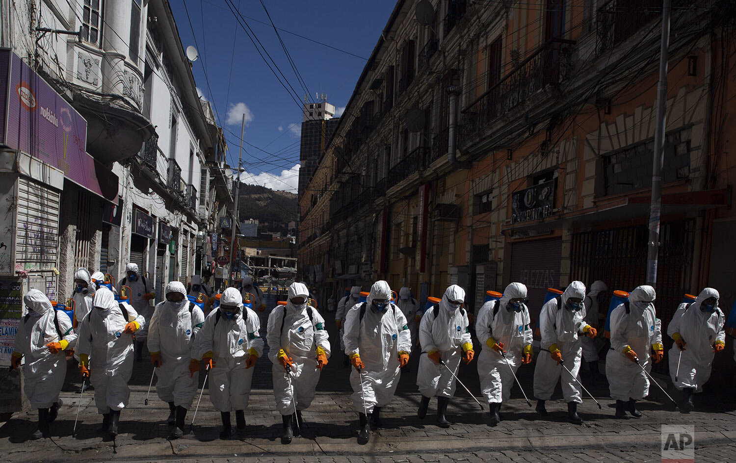  City workers fumigate a street to help contain the spread of COVID-19 in La Paz, Bolivia, Thursday, April 2, 2020. (AP Photo/Juan Karita) 