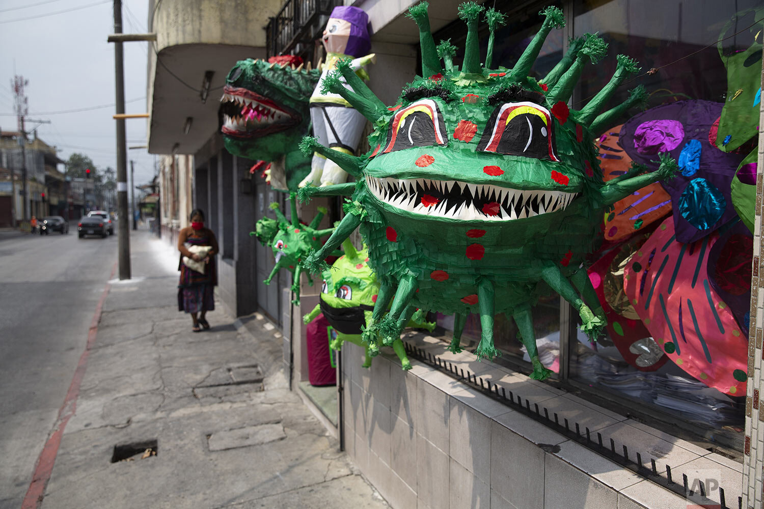  Piñatas depicting the new coronavirus are displayed in a store at Colon park in Guatemala City, Tuesday, April 14, 2020. The piñatas sell for about $1.50 depending on the size. (AP Photo/Moises Castillo) 