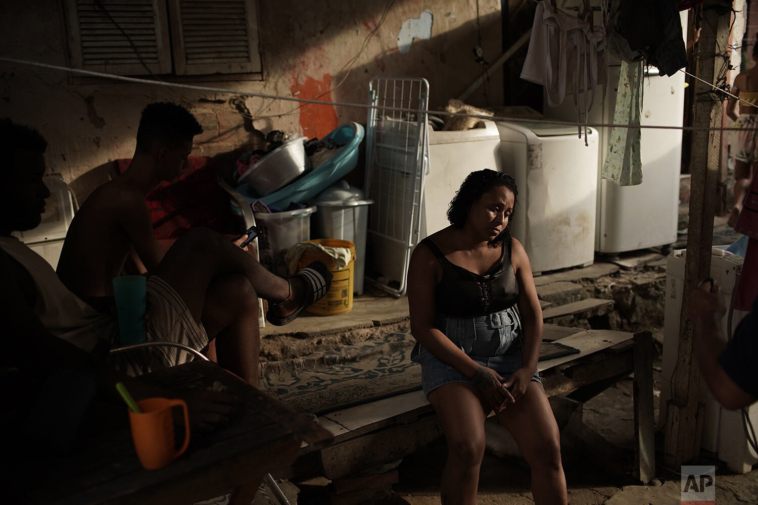  Manicurist and mother of seven children Leticia Machado, who is jobless due to the novel coranvirus pandemic, sits on a bench in her home during the new coronavirus pandemic, at the Turano favela, in Rio de Janeiro, Brazil, April 15, 2020. (AP Photo