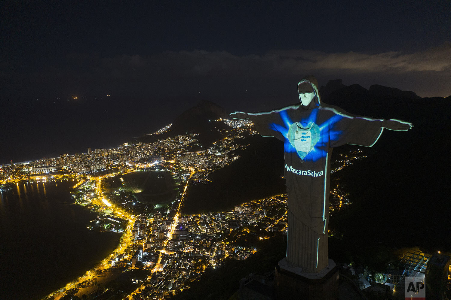  The iconic Christ the Redeemer statue is lit up as if wearing a protective mask and with a hashtag that reads in Portuguese: "Mask saves,Ó amid the new coronavirus pandemic, in Rio de Janeiro, Brazil, May 3, 2020. (AP Photo/Leo Correa) 