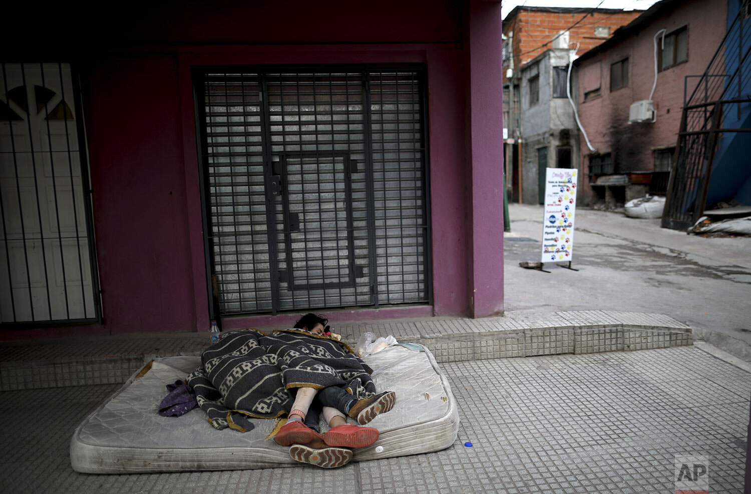  Homeless women sleep outside on a mattress in "Villa 31" in Buenos Aires, Argentina, Wednesday, May 6, 2020. (AP Photo/Natacha Pisarenko) 