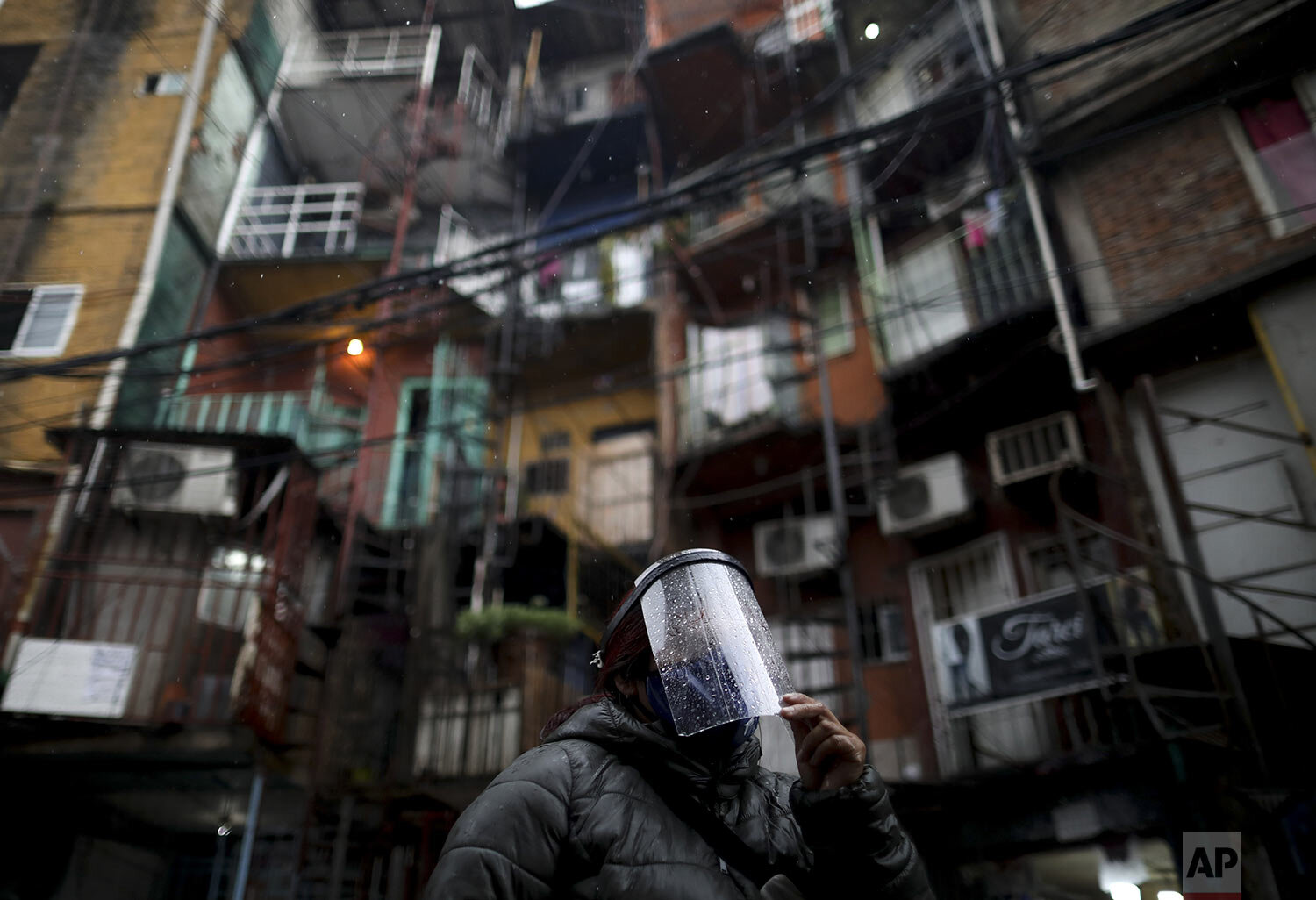  A woman wears a face shield in “Villa 31” in Buenos Aires, Argentina, Monday, May 4, 2020. (AP Photo/Natacha Pisarenko) 