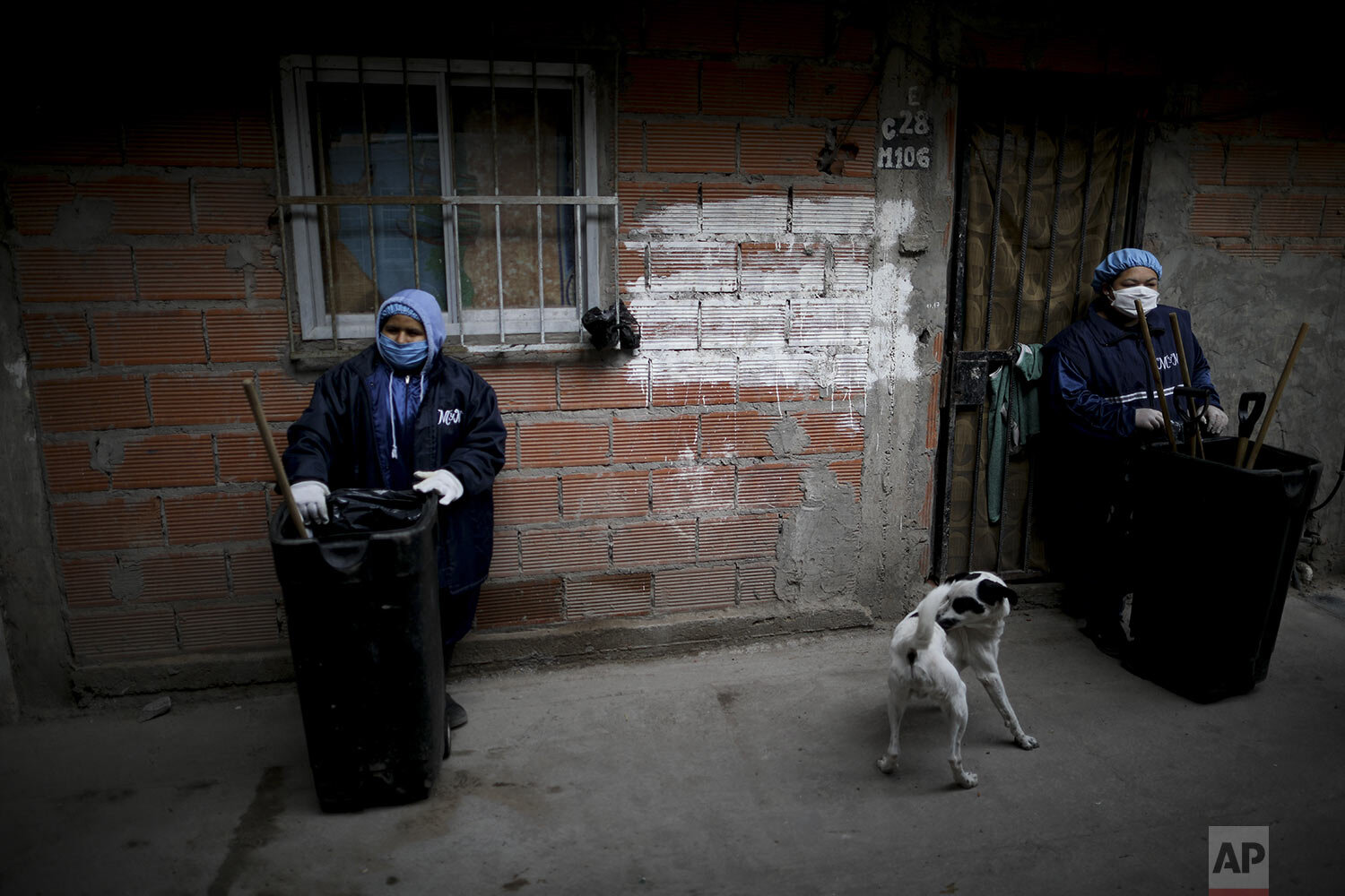  Trash workers wearing face masks, gloves and head gear, rest as they work in “Villa 31” in Buenos Aires, Argentina, Tuesday, May 5, 2020. (AP Photo/Natacha Pisarenko) 