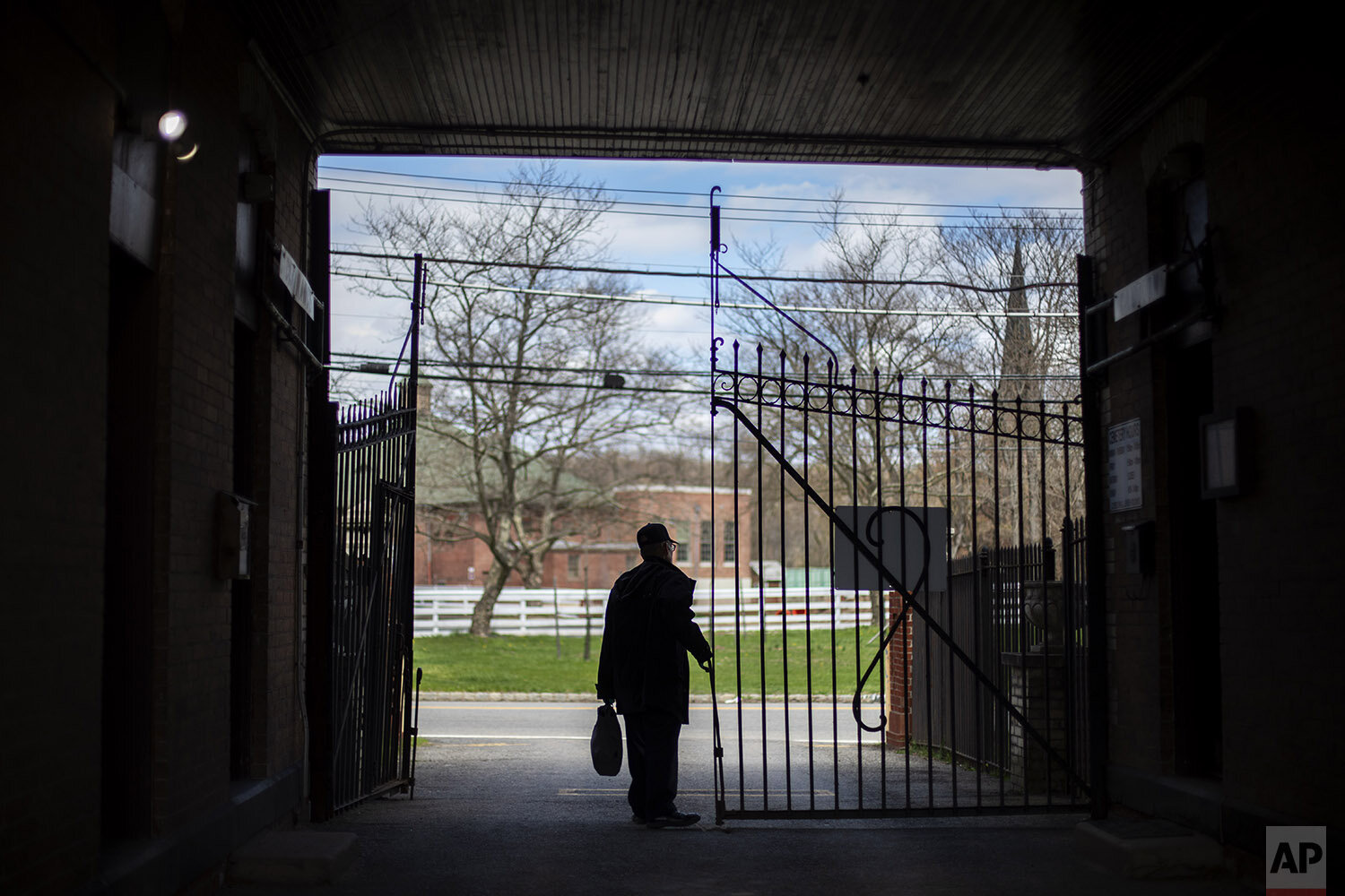  Rabbi Shmuel Plafker closes the gates after another day of keeping pace with a surge in burials, most of them deaths from coronavirus, at the Hebrew Free Burial Association's cemetery in the Staten Island borough of New York, Wednesday, April 8, 202