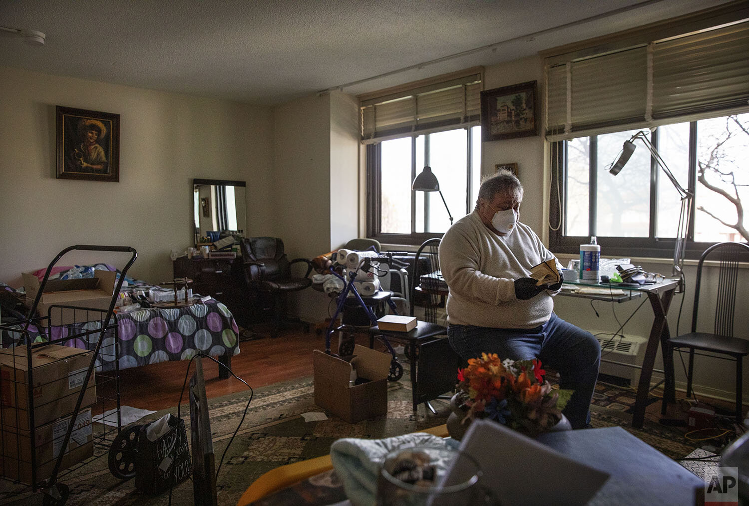  Michael Tokar packs up the apartment of his father, David Tokar, after he died from complications from coronavirus, in the Brooklyn borough of New York, Sunday, April 12, 2020. "I miss him. I like to call him sometimes. Ask him what you need, what y
