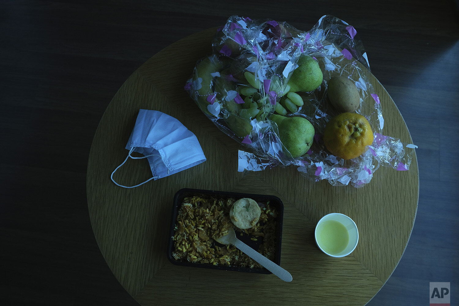  In this April 23, 2020, photo, a mask lies along with food on a table in the hotel room of Associated Press photographer Rafiq Maqbool where he was quarantined in Mumbai, India. Maqbool was tested positive for COVID-19 with dozens of other journalis