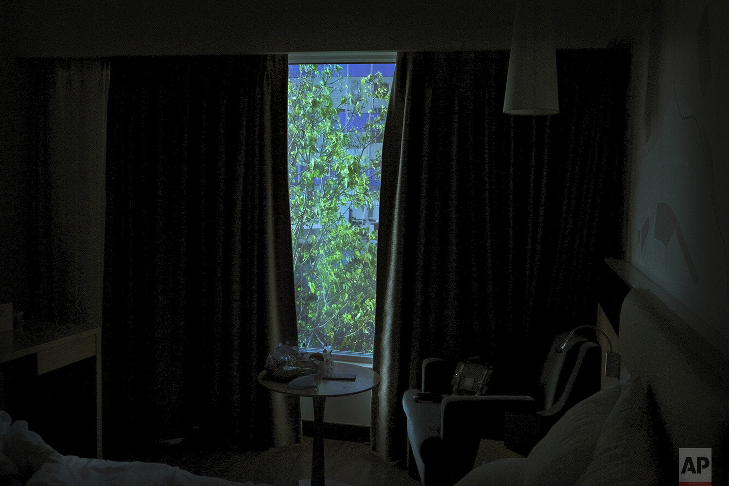  In this April 23, 2020, photo, a tree is seen from the window of a hotel room where Associated Press photographer Rafiq Maqbool has been placed under quarantine in Mumbai, India. Maqbool was tested positive for COVID-19 with dozens of other journali