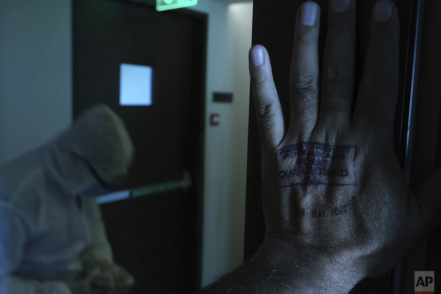 In this April 24, 2020, photo, a stamp for a 14-day home quarantine is seen on the hand of Associated Press photographer Rafiq Maqbool, at a hotel where he was under quarantine, in Mumbai, India. Maqbool was among dozens of journalists who tested po