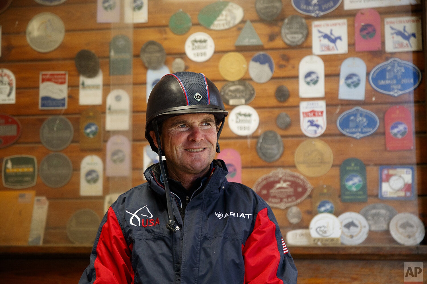  Phillip Dutton, a medal-winning equestrian on the U.S. Olympic team, poses for a photograph after a training session at his farm, Thursday, April 2, 2020, in West Grove, Pa. (AP Photo/Matt Slocum) 