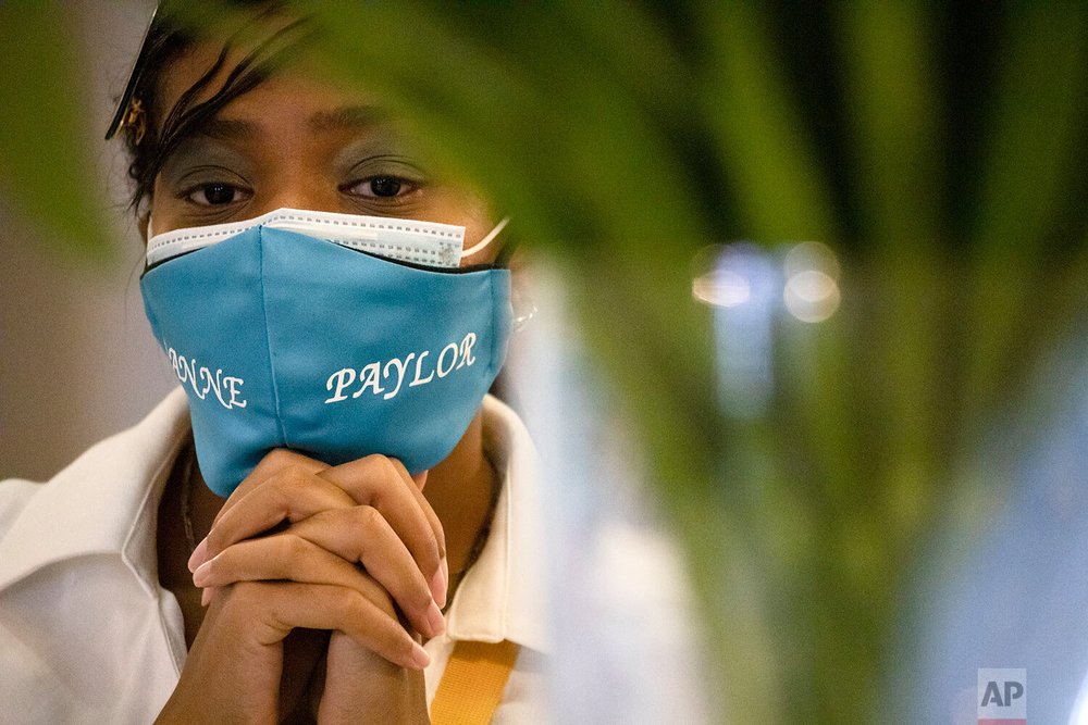 Funeral delayed: tiaras, white outfits, turquoise face masks — AP Photos