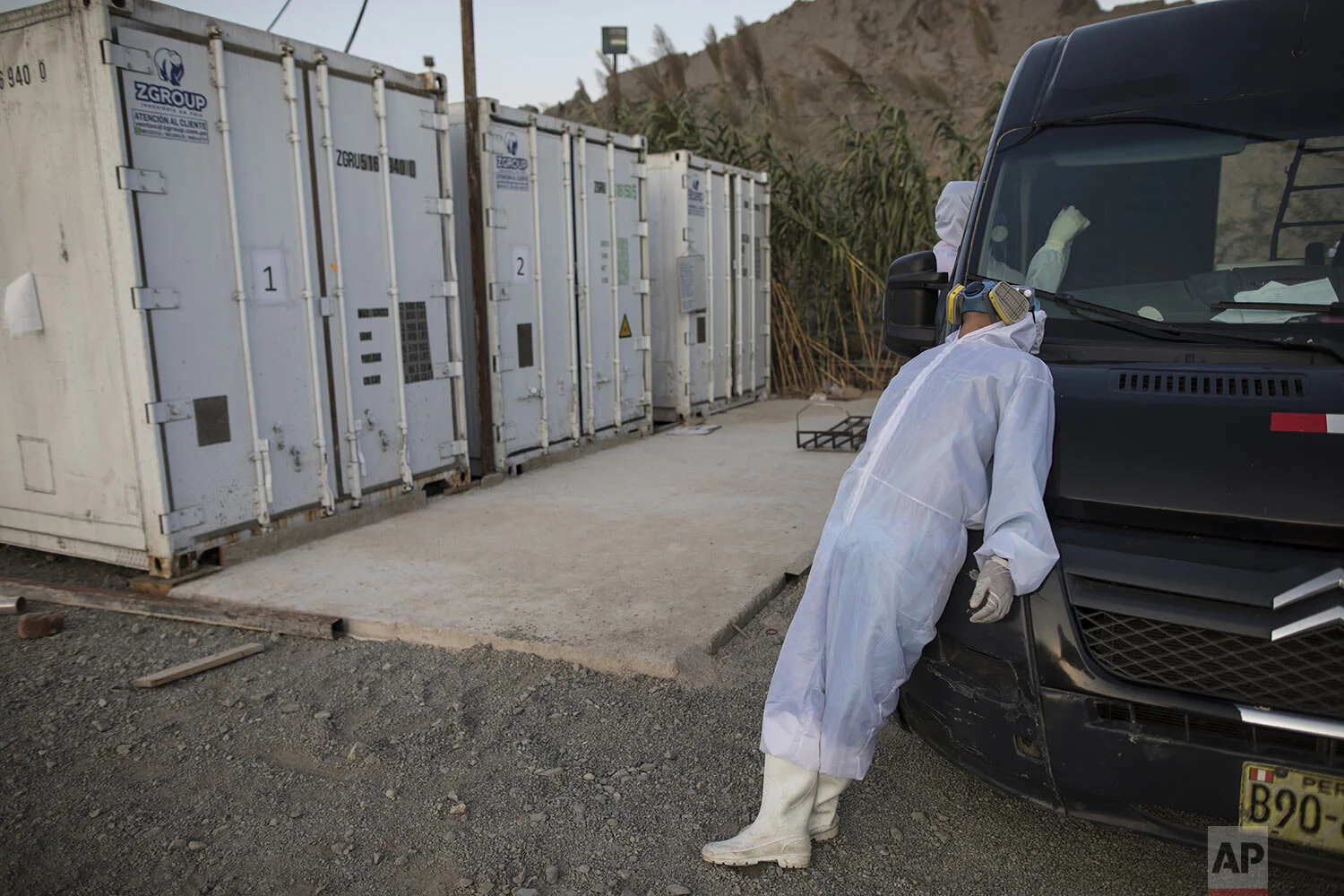  Piedrangel funeral home worker Angelo Aza, of Venezuela, rests leaning on the company van transporting bodies of people suspected to have died from the new coronavirus, next to maritime containers installed to keep bodies refrigerated at zero degree