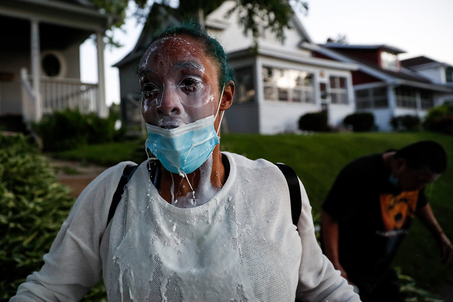  A protestor douses her face with milk after being exposed to tear gas fired by police, Thursday, May 28, 2020, in St. Paul, Minn. Protests over the death of George Floyd, a black man who died in police custody Monday, broke out in Minneapolis for a 
