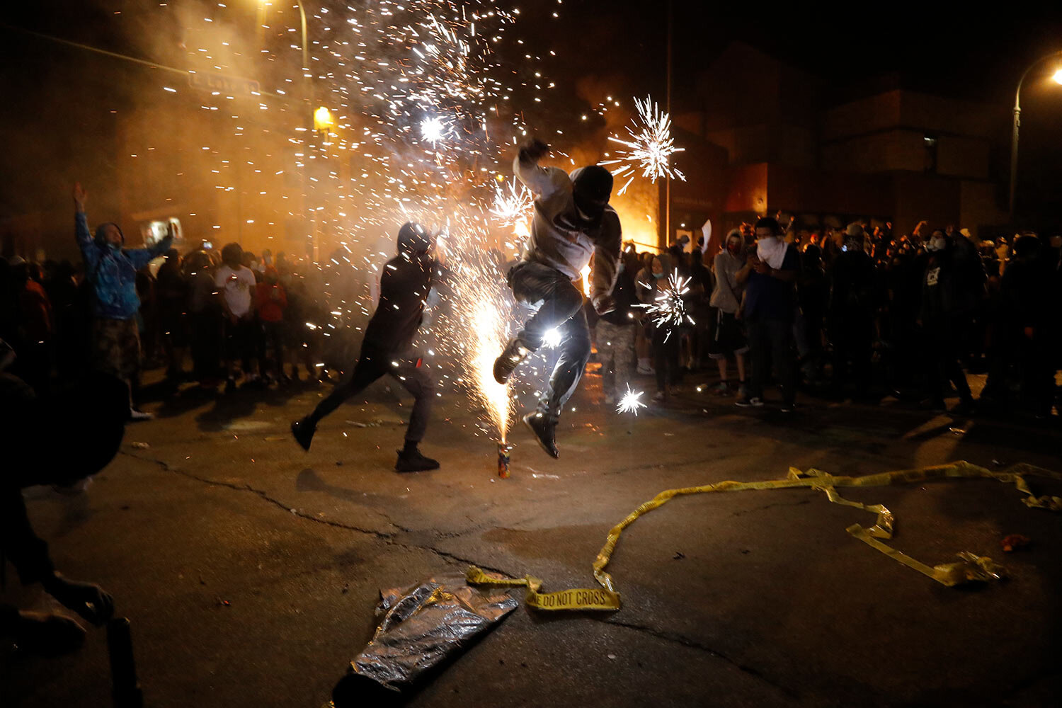  Protesters set off fireworks as a fire burns at the Minneapolis police 3rd Precinct building Thursday, May 28, 2020, in Minneapolis. (AP Photo/Julio Cortez) 