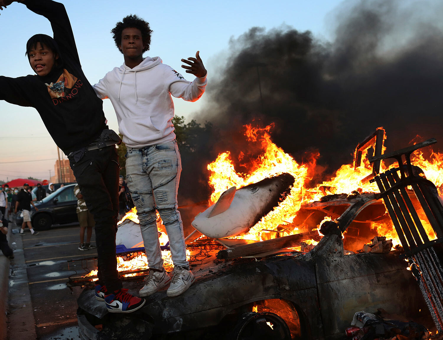 Young men stand atop a burning car in the Target parking lot E. Lake St. during a third night of unrest following the death of George Floyd while in Minneapolis police custody early in the week and seen Thursday, May 28, 2020, in Minneapolis, MN. (E