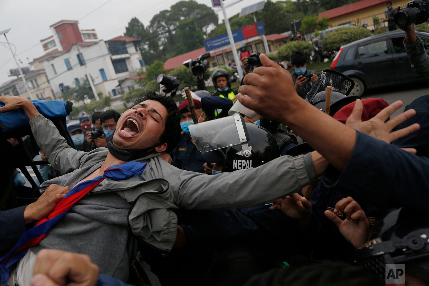  Nepalese students shout slogans as they are detained by policemen during a protest amid lockdown in Kathmandu, Nepal, Monday, May 11, 2020. (AP Photo/Niranjan Shrestha) 