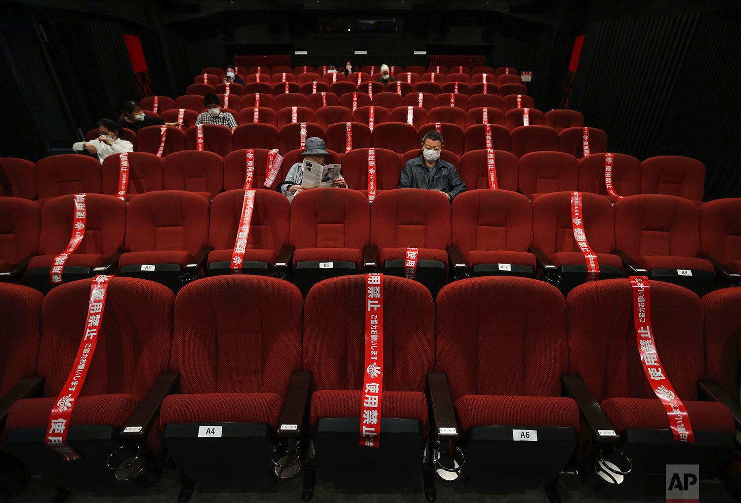  Red tape blocks off seats in an attempt to promote social distancing at a movie theater which reopened in Kyoto, western Japan, Saturday, May 23, 2020. (Kyodo News via AP) 