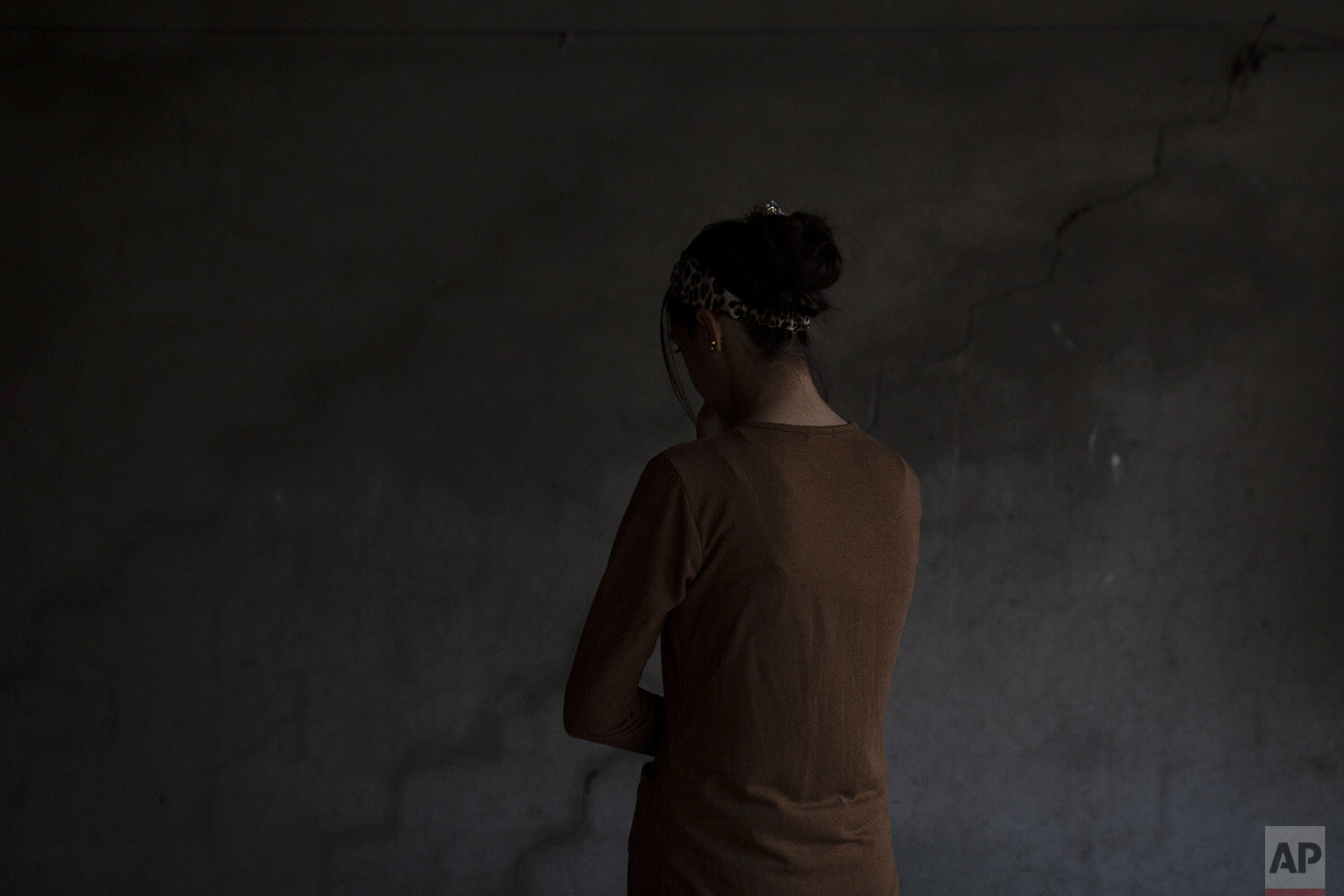  In this Nov. 15, 2019, photo, a Yazidi woman who endured five years of captivity by Islamic State militants poses for a portrait in her home in northern Iraq. “They beat me and sold me and did everything to me,” she says. Raped by nearly a dozen own